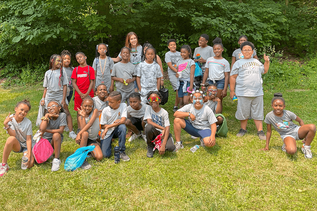 MACS students pose together in grass field.