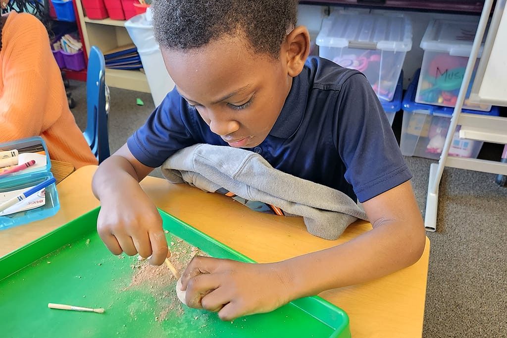 A student working on a project at their desk.