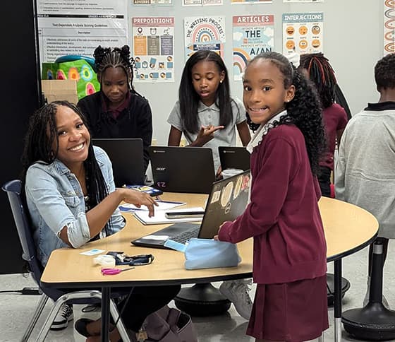 A student working with a teacher.