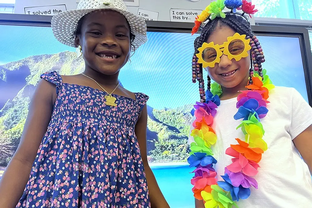 Two smiling students in colorful costumes. Two smiling students in colorful costumes.