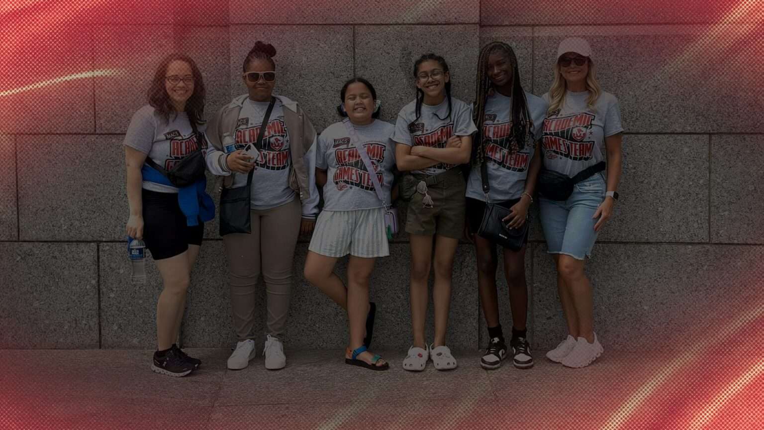 Four girls pose with two teachers in Washington DC.