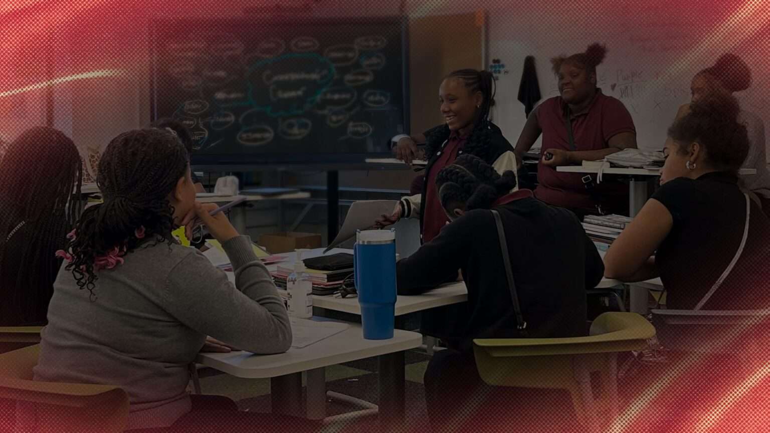 A female student speaks in front of classmates.