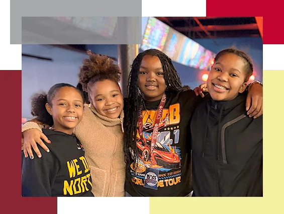 Four girls pose for a picture during a field trip.