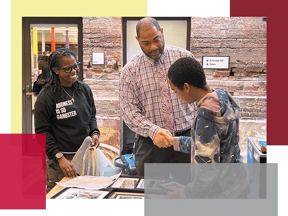 The principal shakes a students hand.