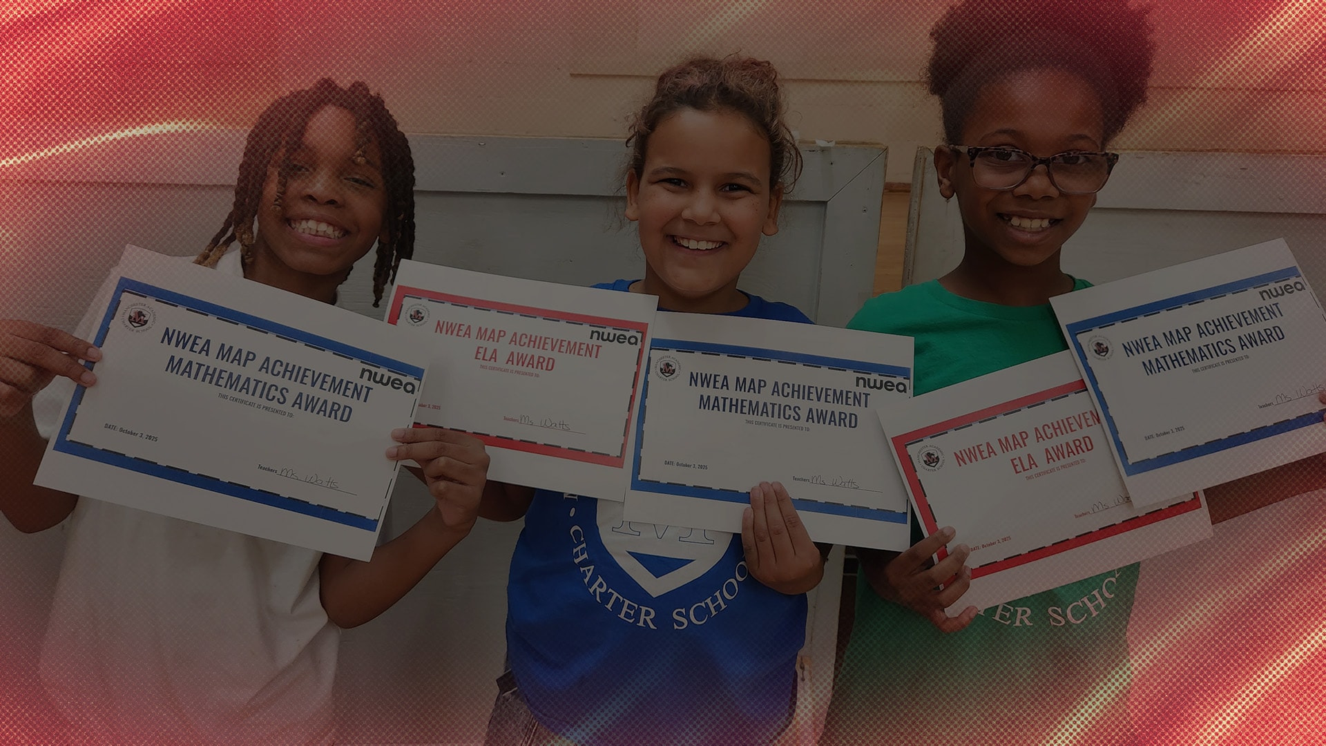 Three students hold up award certificates.